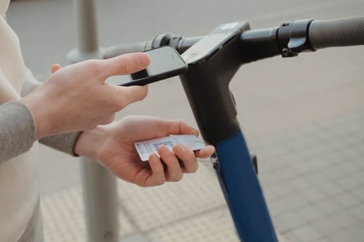 a-man-scans-an-electric-scooter-qr-code-for-rent-pay